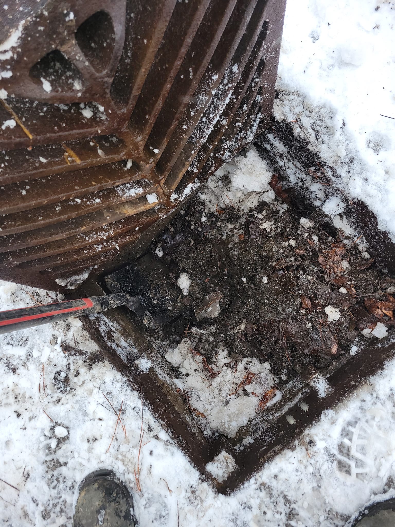 Catch basin full of debris, prior to cleaning.
